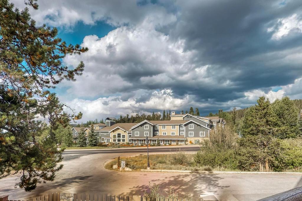 a row of houses on a road with a cloudy sky at Corral at Breckenridge in Breckenridge