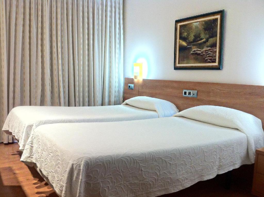 Ένα ή περισσότερα κρεβάτια σε δωμάτιο στο Hostal Del Carmen