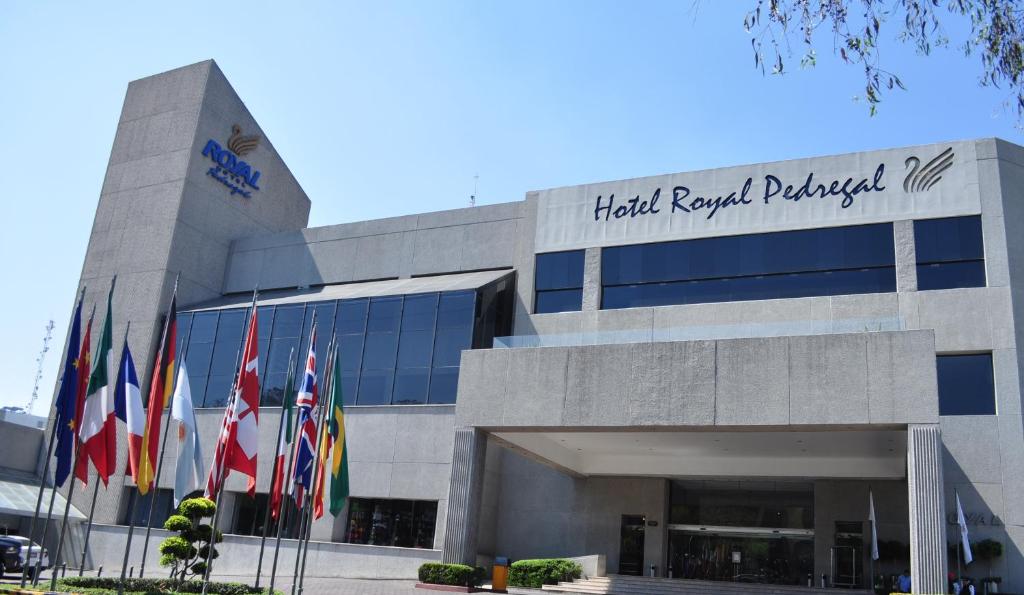 a building with flags in front of it at Royal Pedregal in Mexico City