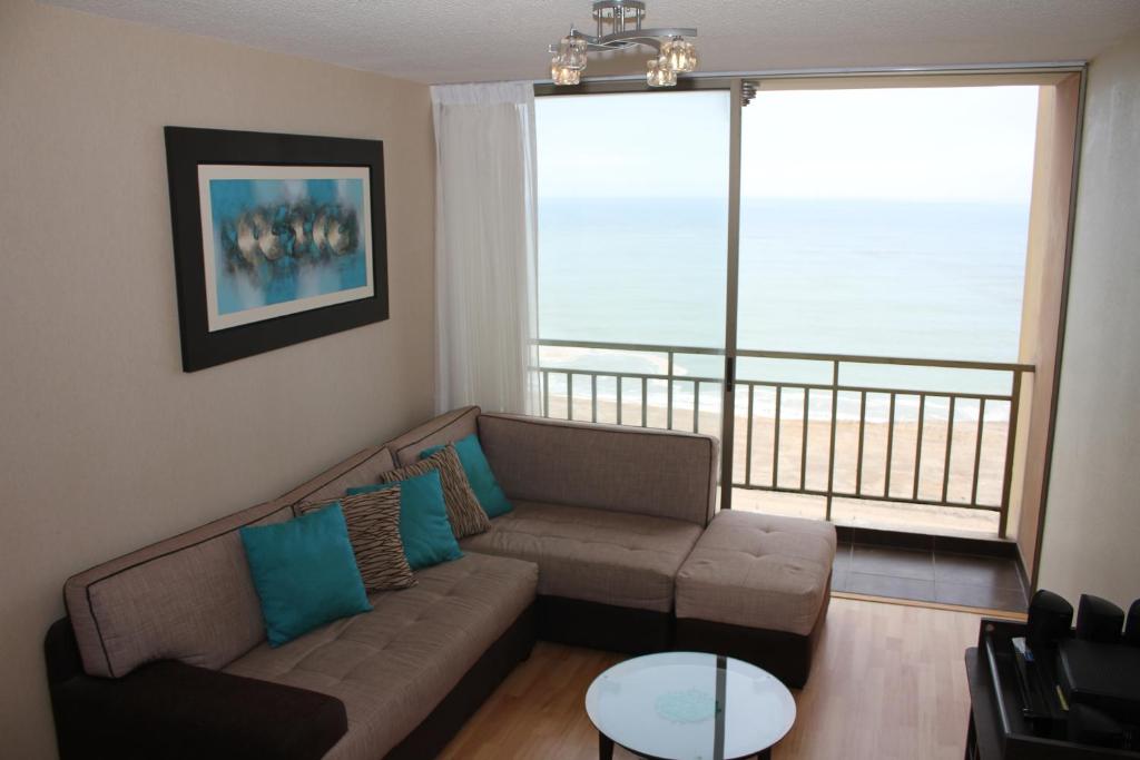 a living room with a couch and a large window at Condominio Paseo Vista Mar in Lima