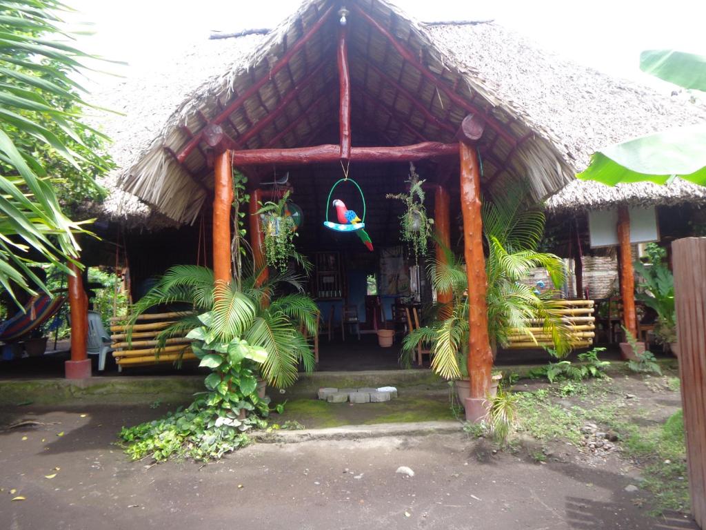 a small house with a thatched roof at Hostal Rancho Sabor Isleño - Ometepe in Altagracia