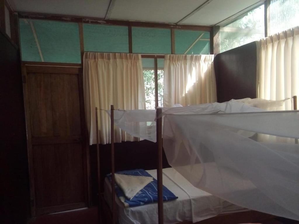 a bedroom with two bunk beds and a window at Tambopata River in Puerto Maldonado