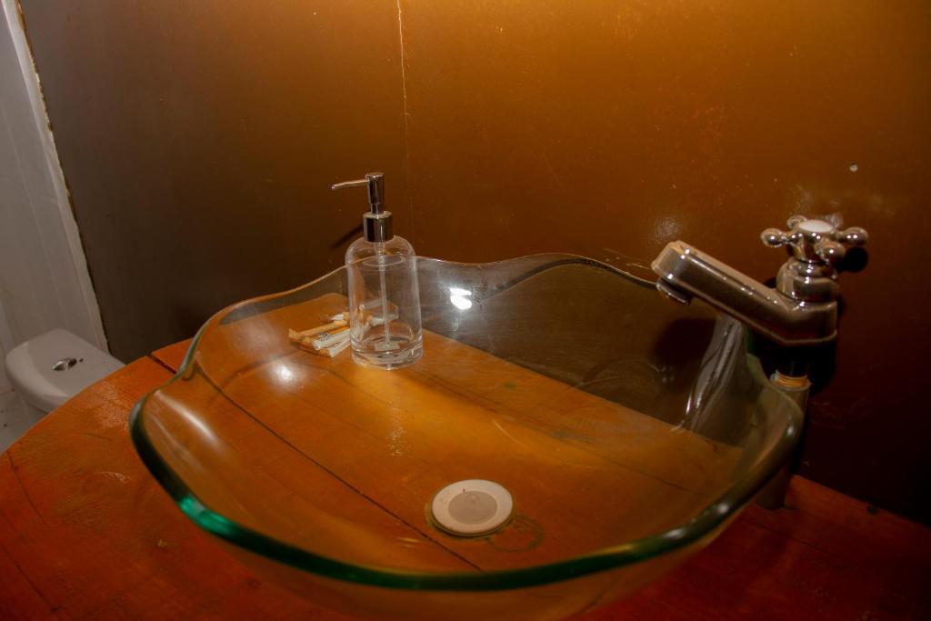 a bathroom with a sink with a glass sink at Tambopata River in Puerto Maldonado