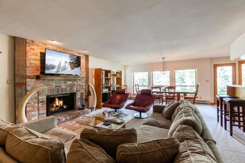 a living room with a couch and a fireplace at Northwoods Ski In Ski Out Access in Vail