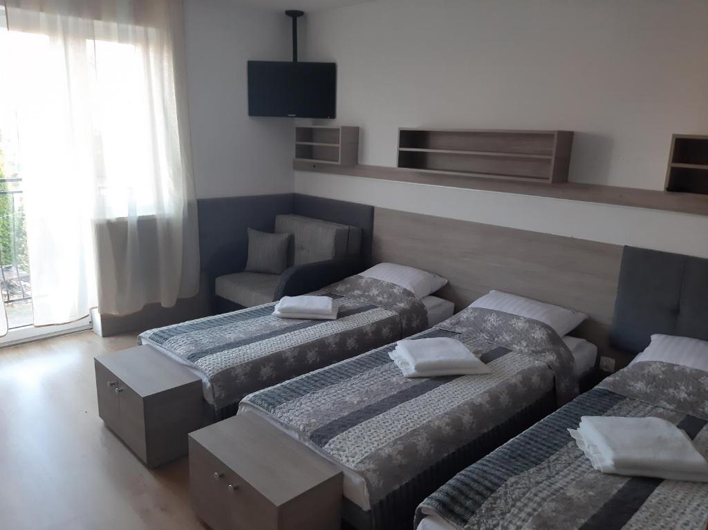 Posteľ alebo postele v izbe v ubytovaní Tasarz Spa Ośrodek Wczasowy