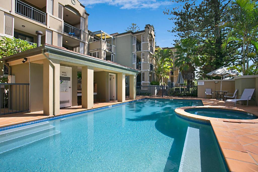 a swimming pool in front of a building at Beaches On Wave Street in Gold Coast