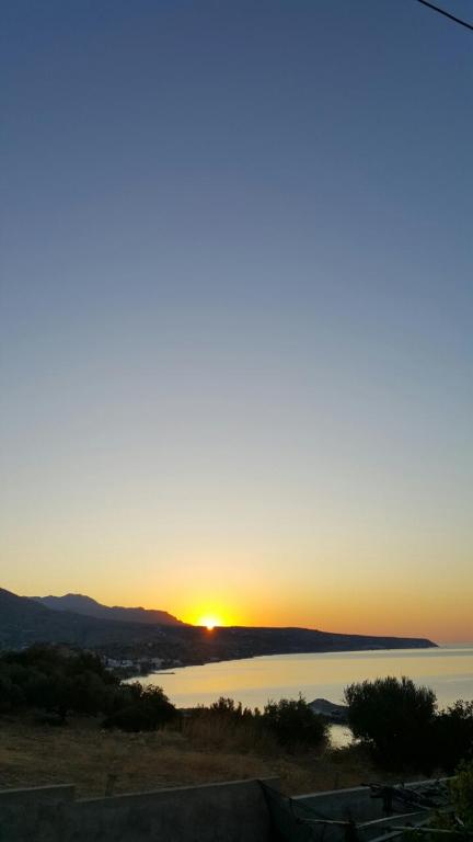 a sunset over a body of water at Porto Kastri Studios in Kastrí