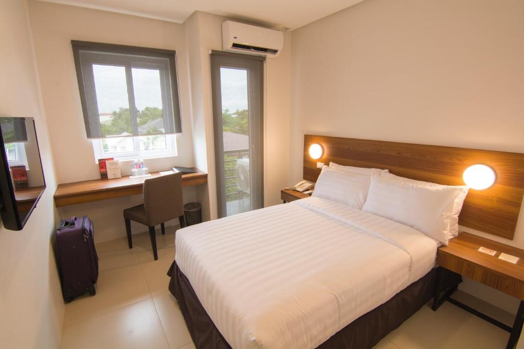 Rúm í herbergi á Mango Suites Cauayan