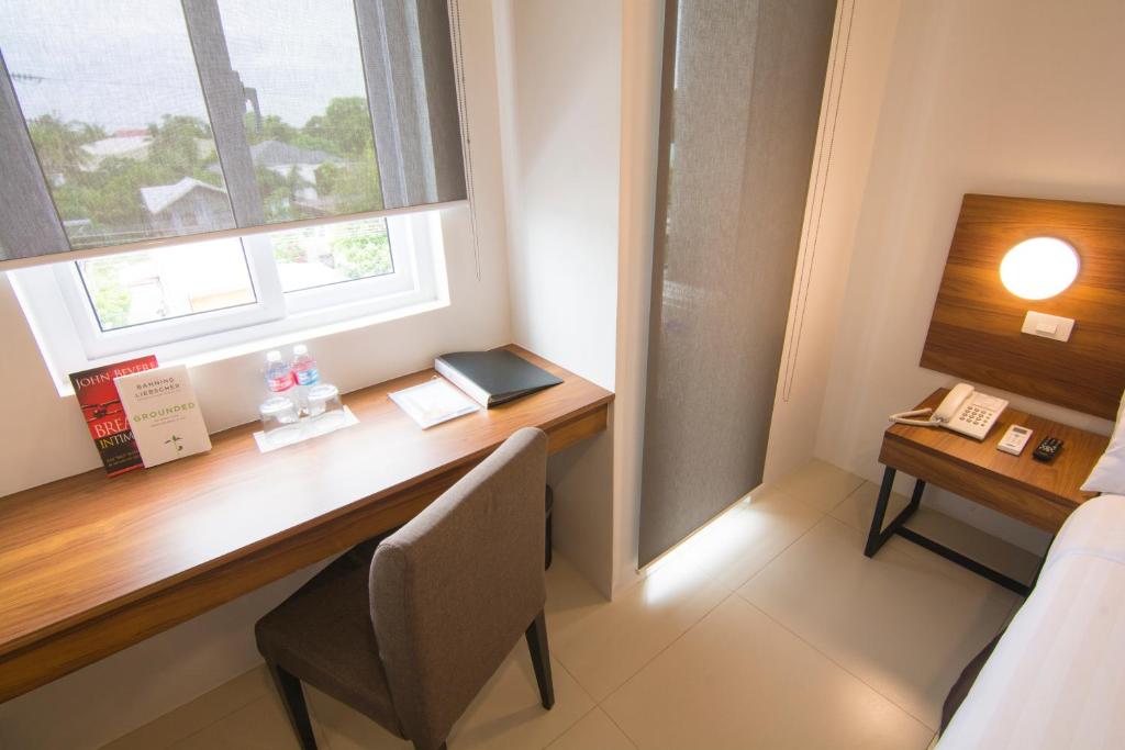Postel nebo postele na pokoji v ubytování Mango Suites Cauayan