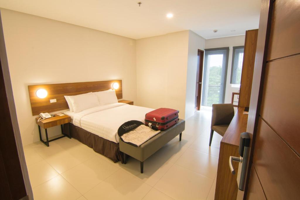 Postel nebo postele na pokoji v ubytování Mango Suites Cauayan