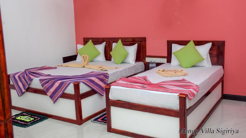 Postel nebo postele na pokoji v ubytování Mango Villa Sigiriya