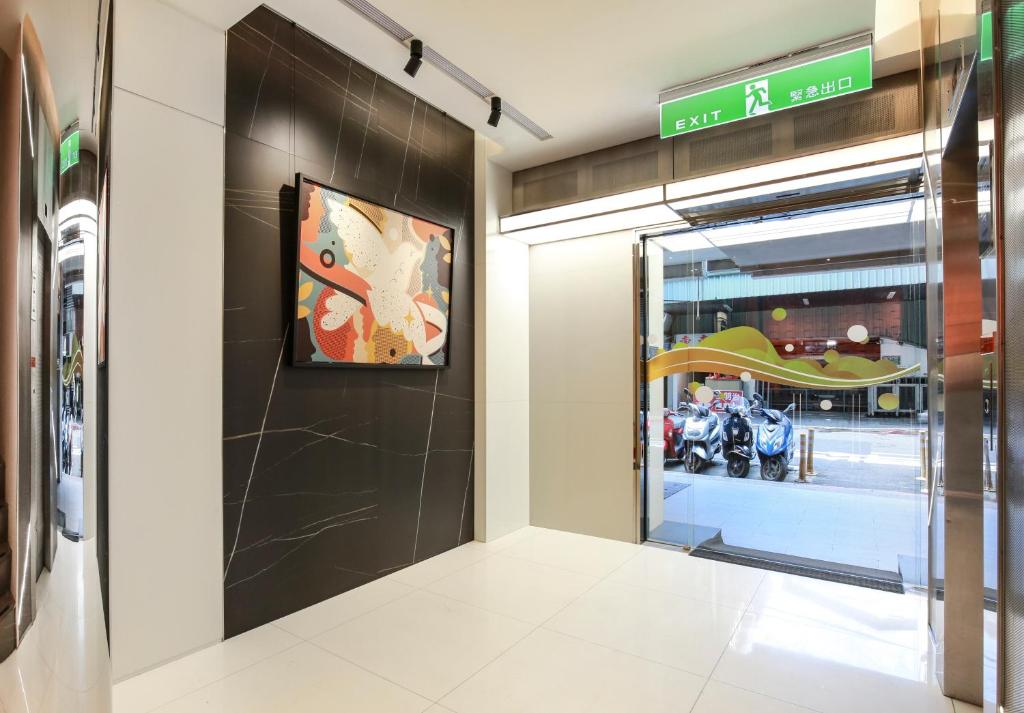 a entrance to a store with a motorcycle in a window at Cityinn Hotel Taipei Station Branch I in Taipei