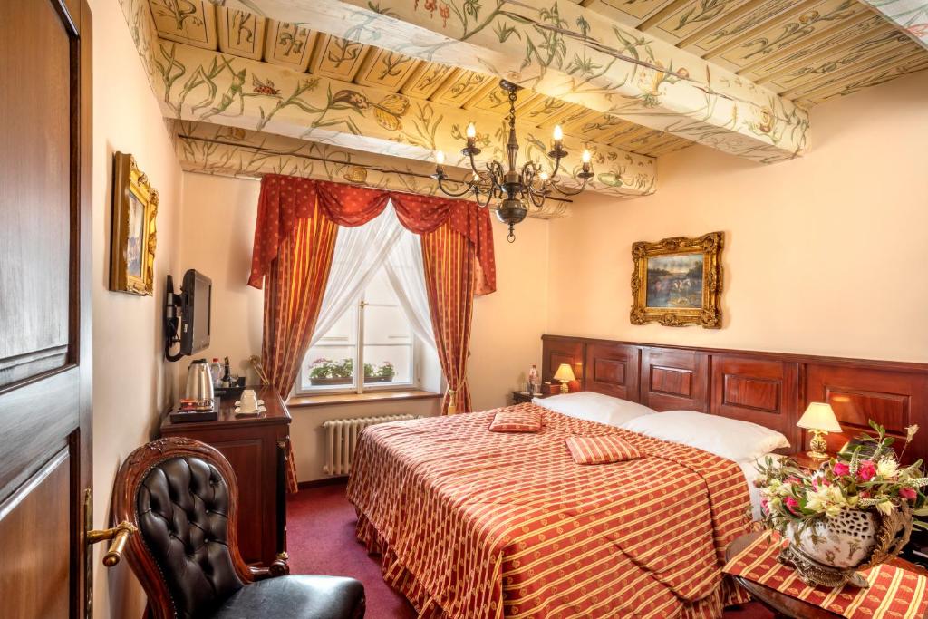 Een bed of bedden in een kamer bij Hotel U Zlateho Stromu