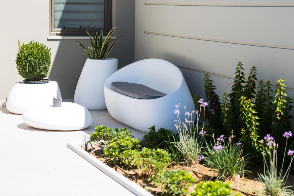 A garden outside Vasilios Villa, with Pool, Gym & Close to Beach, By ThinkVilla
