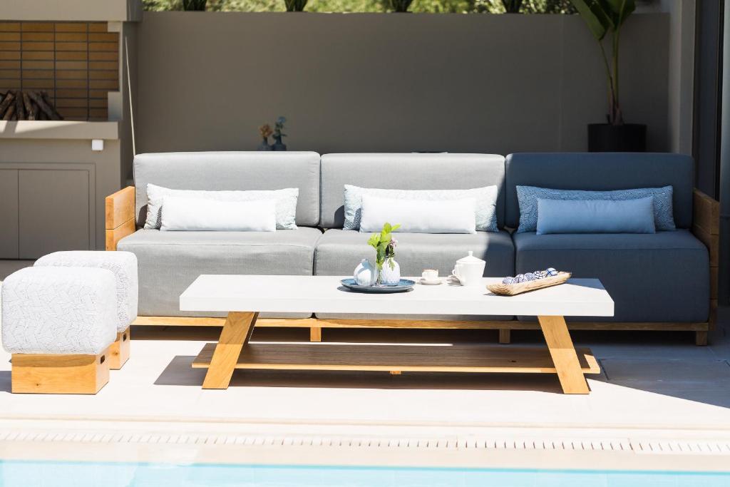 A seating area at Vasilios Villa, with Pool, Gym & Close to Beach, By ThinkVilla