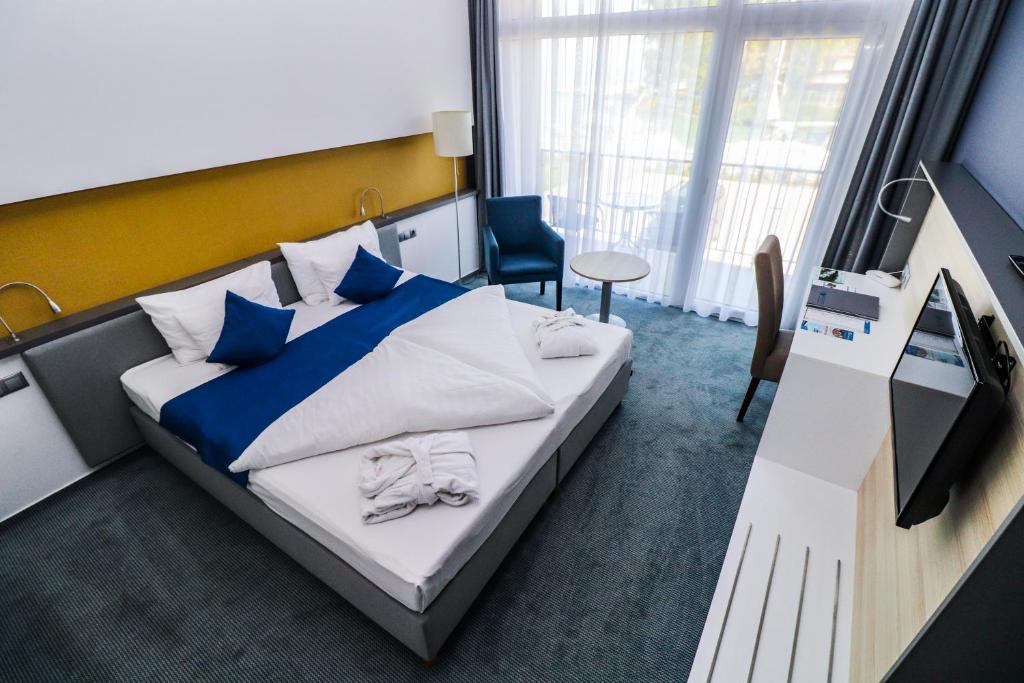 Posteľ alebo postele v izbe v ubytovaní Hotel Yacht Wellness & Business