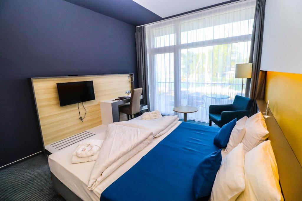 Posteľ alebo postele v izbe v ubytovaní Hotel Yacht Wellness & Business