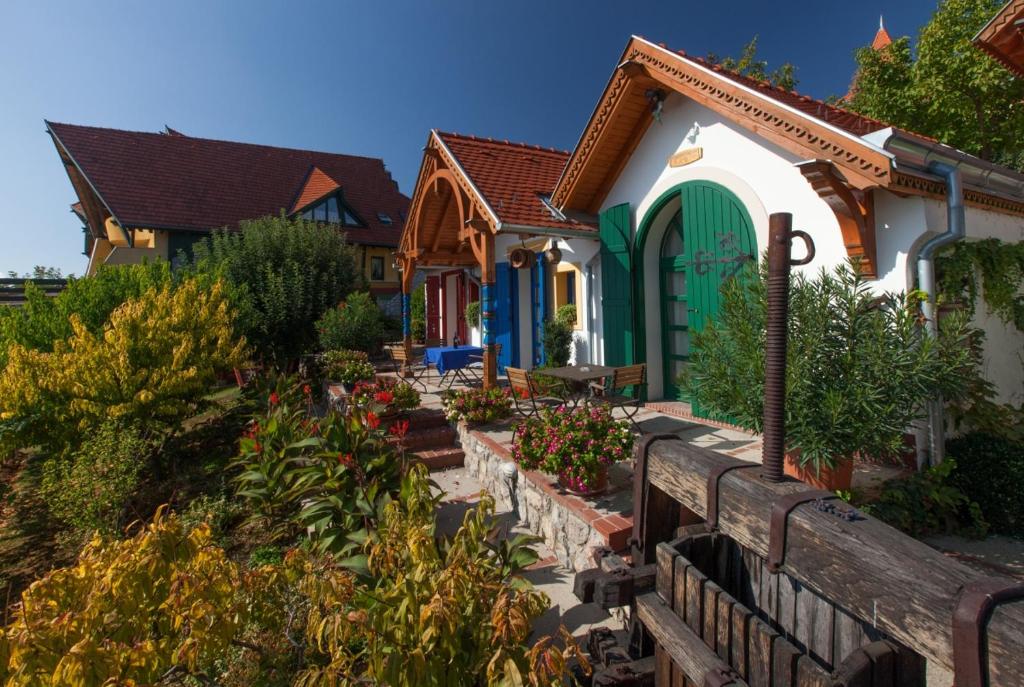 a house with a garden in front of it at Bagoly Pincesor Fogado in Pécs