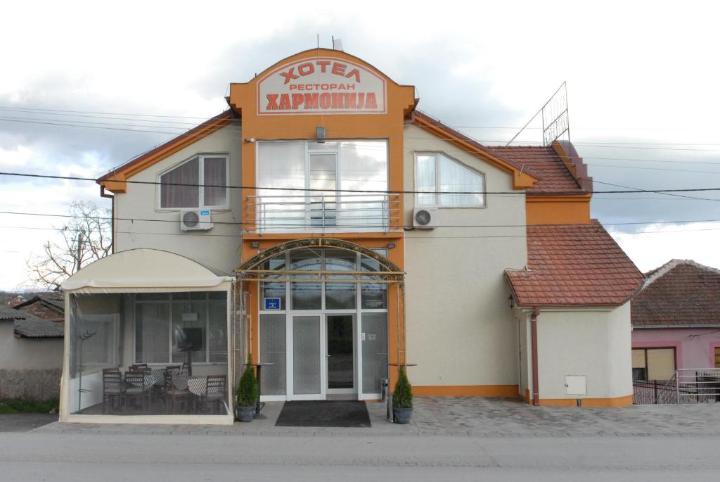 a building with a sign for a restaurant at Harmony Hotel in Kumanovo