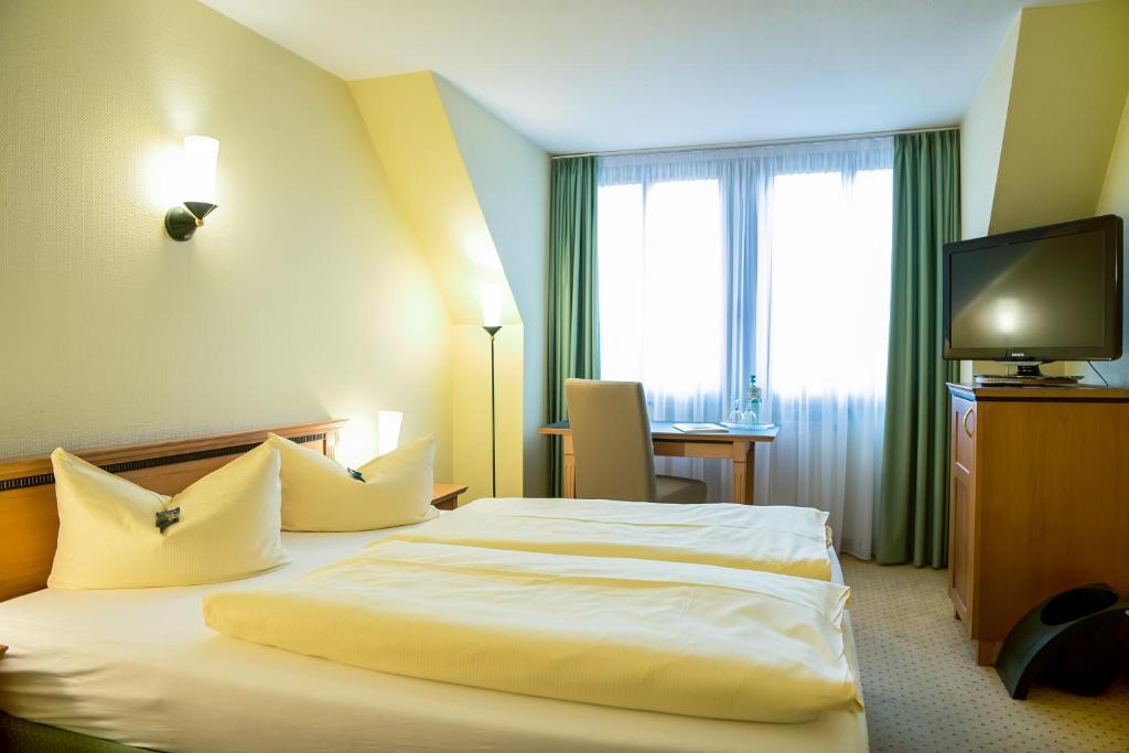 Postel nebo postele na pokoji v ubytování Ringhotel Dreiländereck Zittau