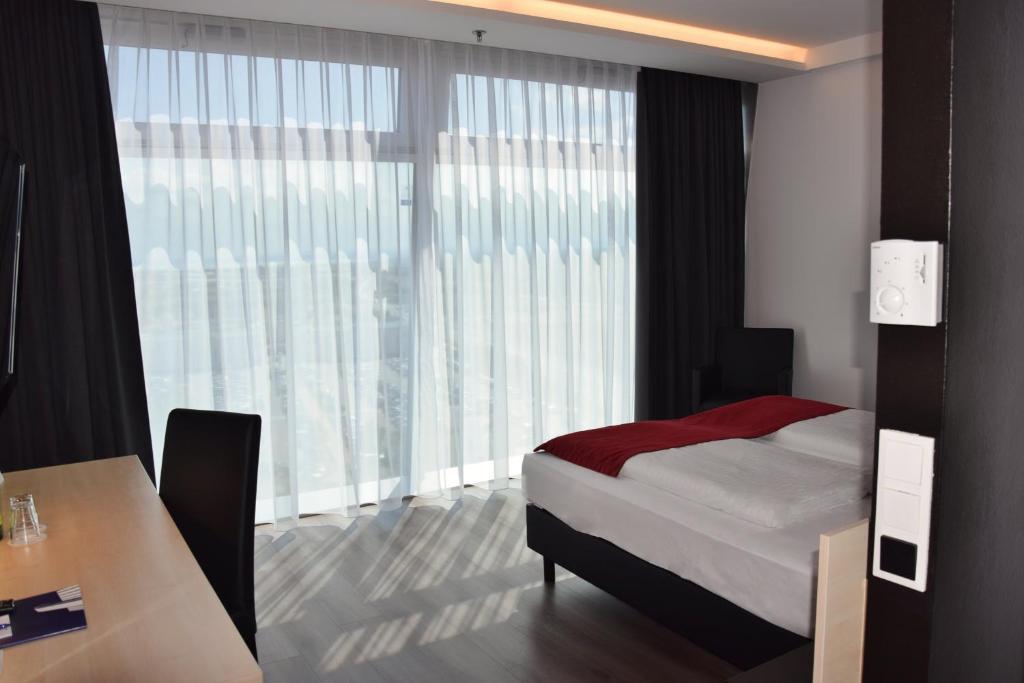 A bed or beds in a room at Pannonia Tower