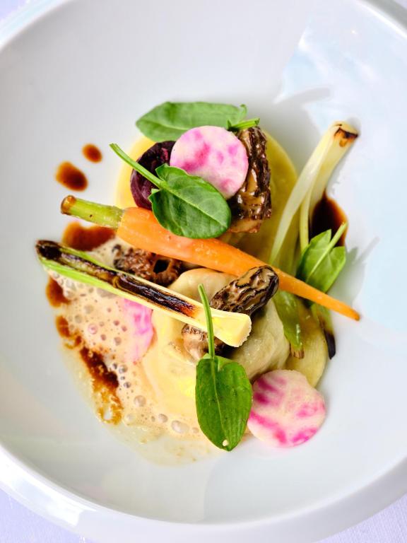 a white plate of food with vegetables on it at Hostellerie de la Renaissance - Teritoria in Argentan