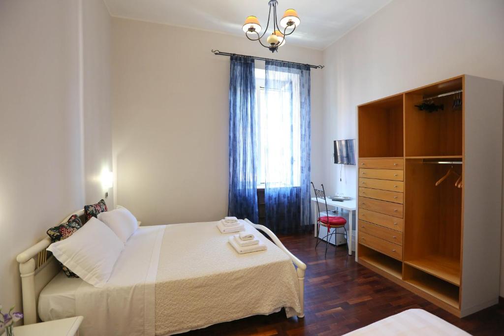 a bedroom with a bed and a dresser and a desk at B&B Residenza MALATERRA in Naples