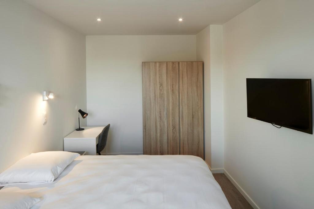 Postel nebo postele na pokoji v ubytování Alpha Hotel and Aparthotel