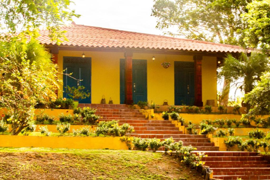 una casa amarilla con escaleras delante en Finca Pamel, en Los Santos