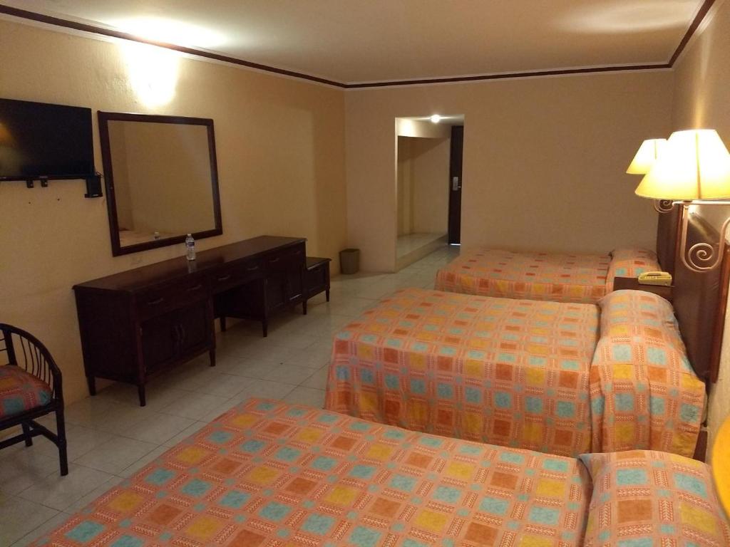 Postel nebo postele na pokoji v ubytování Hotel Acuario de Veracruz