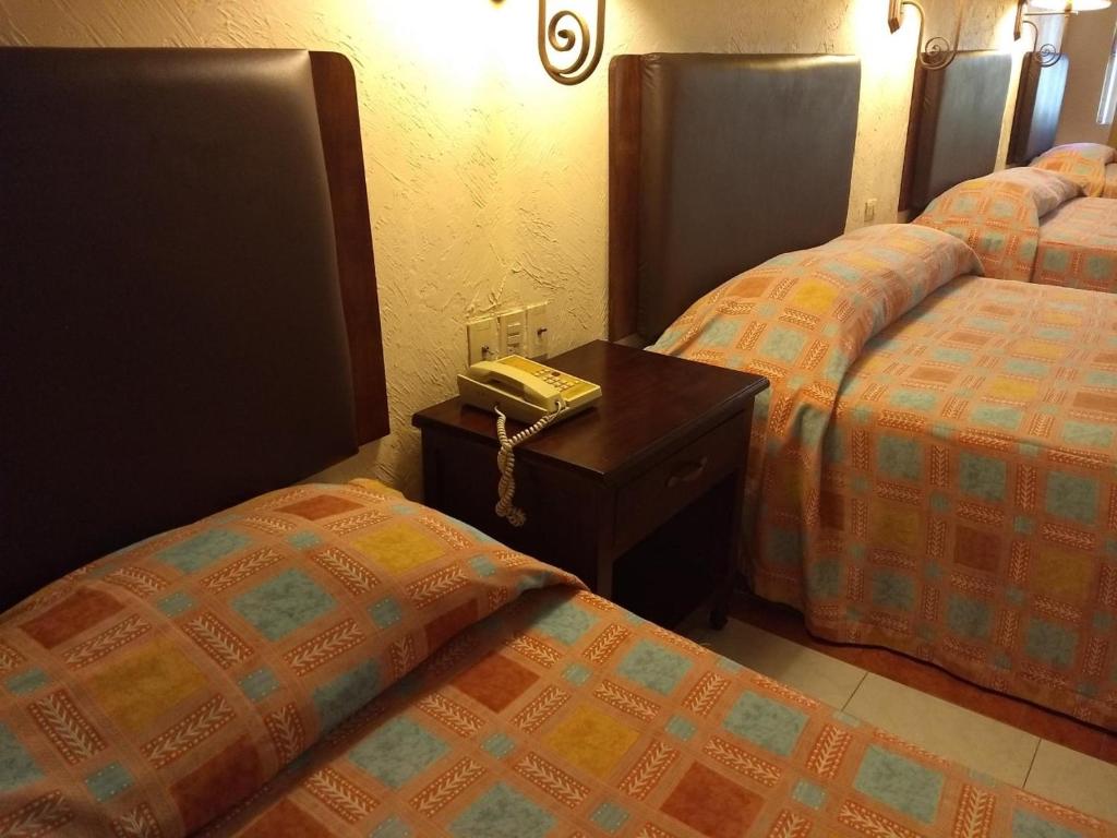 Postel nebo postele na pokoji v ubytování Hotel Acuario de Veracruz