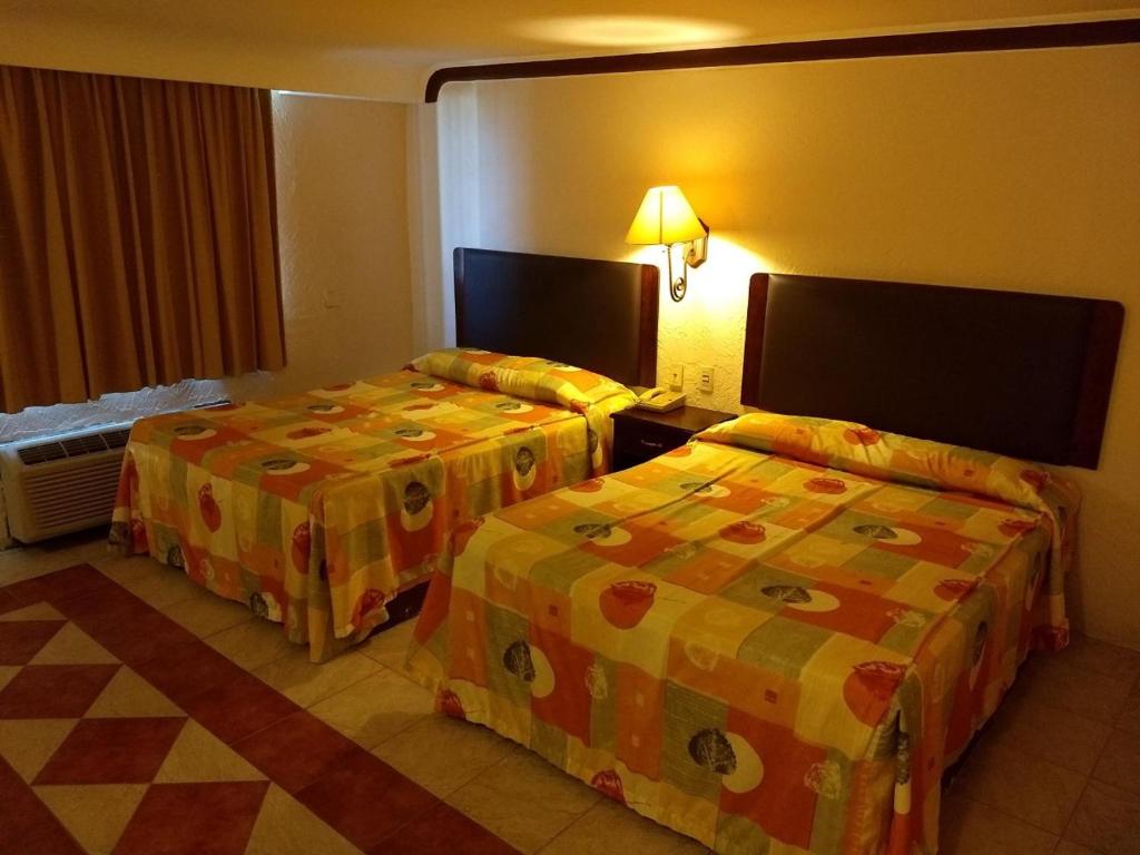 Postel nebo postele na pokoji v ubytování Hotel Acuario de Veracruz