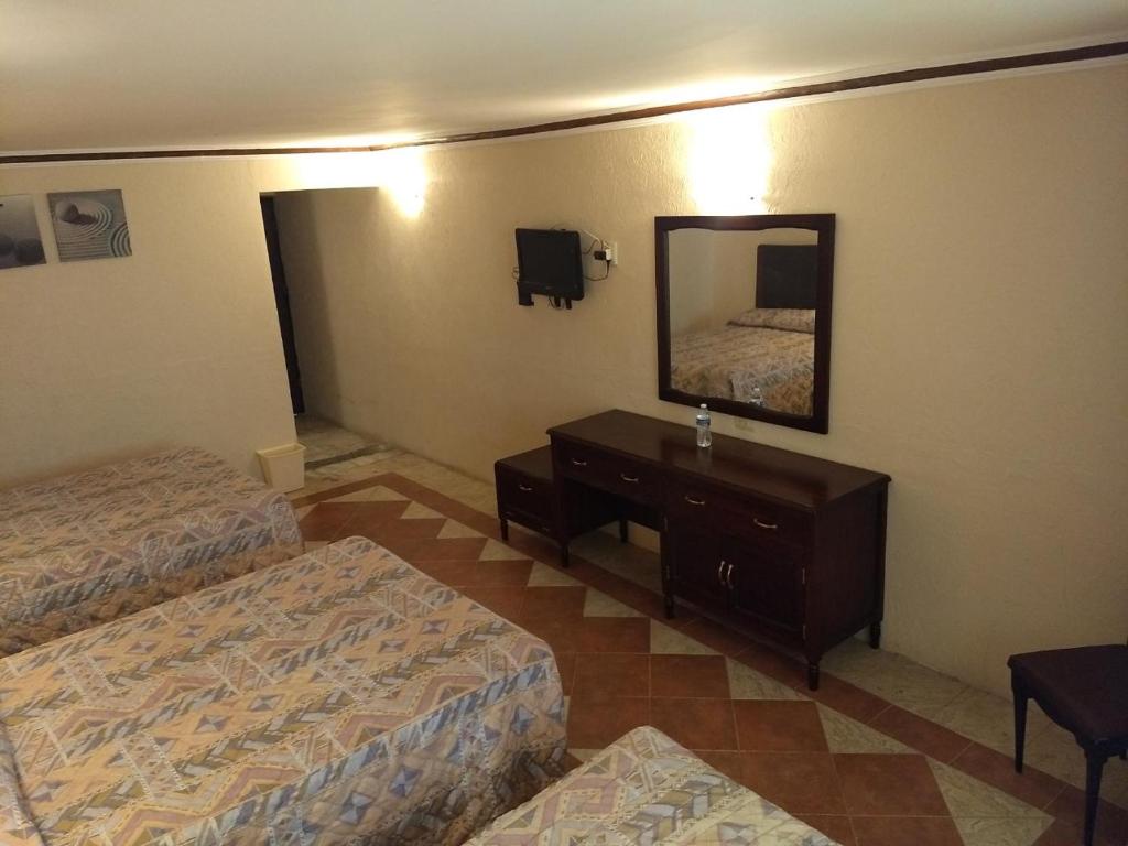 Postel nebo postele na pokoji v ubytování Hotel Acuario de Veracruz