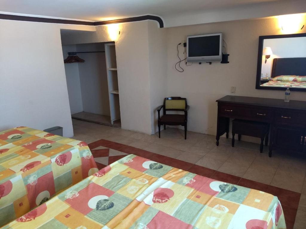 Postel nebo postele na pokoji v ubytování Hotel Acuario de Veracruz