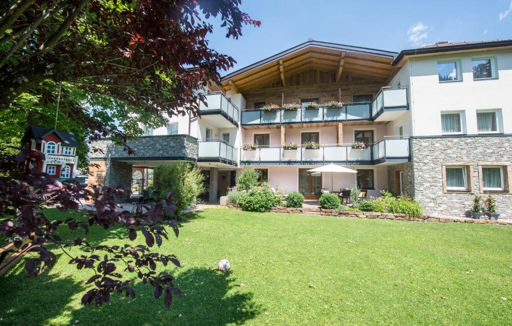 an exterior view of a building with a yard at Aparthotel Kristall in Altenmarkt im Pongau