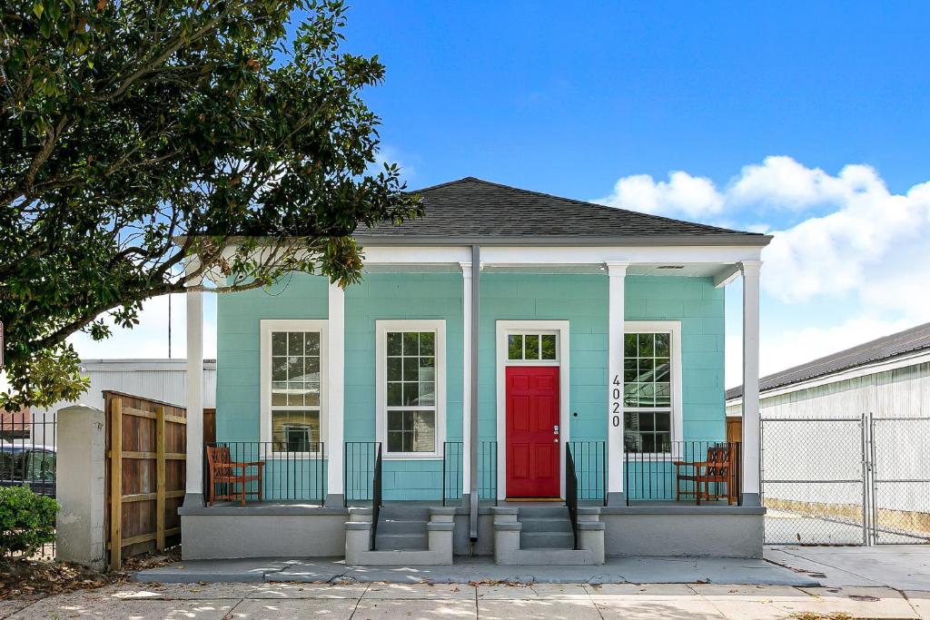 a blue and red house with a red door at Cozy and Charming House with Luxury Amenities in New Orleans