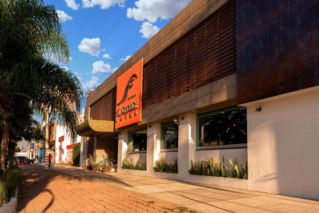 a building with a sign on the side of it at Hotel St. George in Celaya