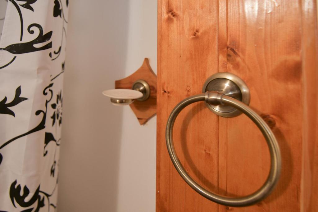 a wooden door with a metal handle on it at Kerti lak in Mór