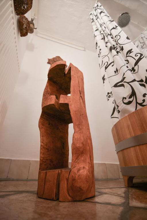 a wooden arch in a room with writing on the wall at Kerti lak in Mór