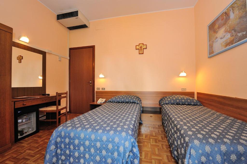 Postel nebo postele na pokoji v ubytování Hotel Frate Sole