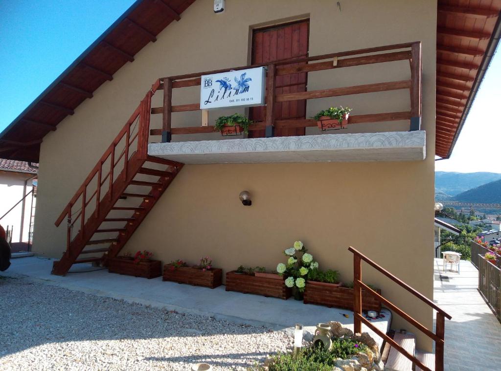 a staircase on the side of a house with potted plants at Lilium in LʼAquila