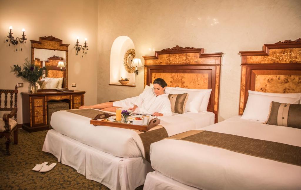 Postel nebo postele na pokoji v ubytování Aranwa Cusco Boutique Hotel