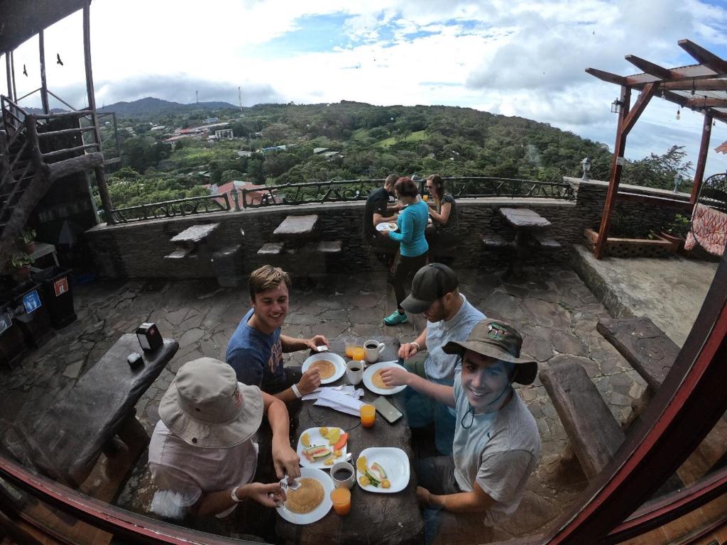 a group of people sitting around a table eating food at Cabinas Vista Al Golfo in Monteverde Costa Rica