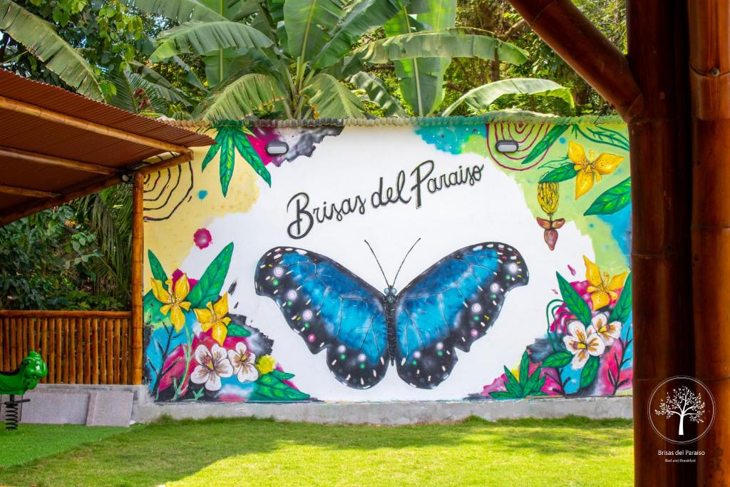 a mural of a butterfly on a wall at Brisas del Paraiso in Manglaralto