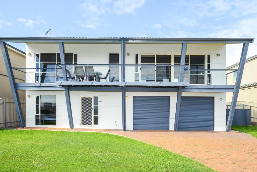 a large white house with two garage doors at Salt - Aldinga Beach - C21 SouthCoast Holidays in Aldinga Beach