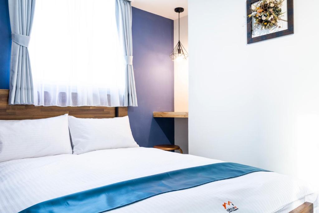 Postel nebo postele na pokoji v ubytování 沐藍輕旅 Mulan Light Inn I 海安路住宿