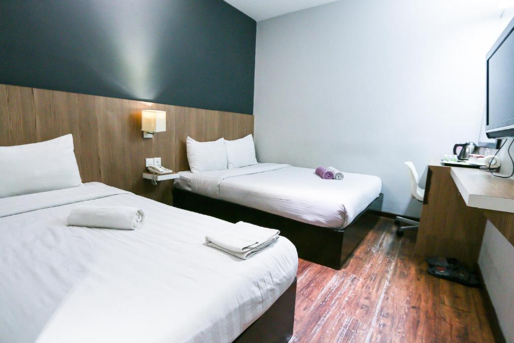 Postel nebo postele na pokoji v ubytování Hotel 99 Botanik Klang