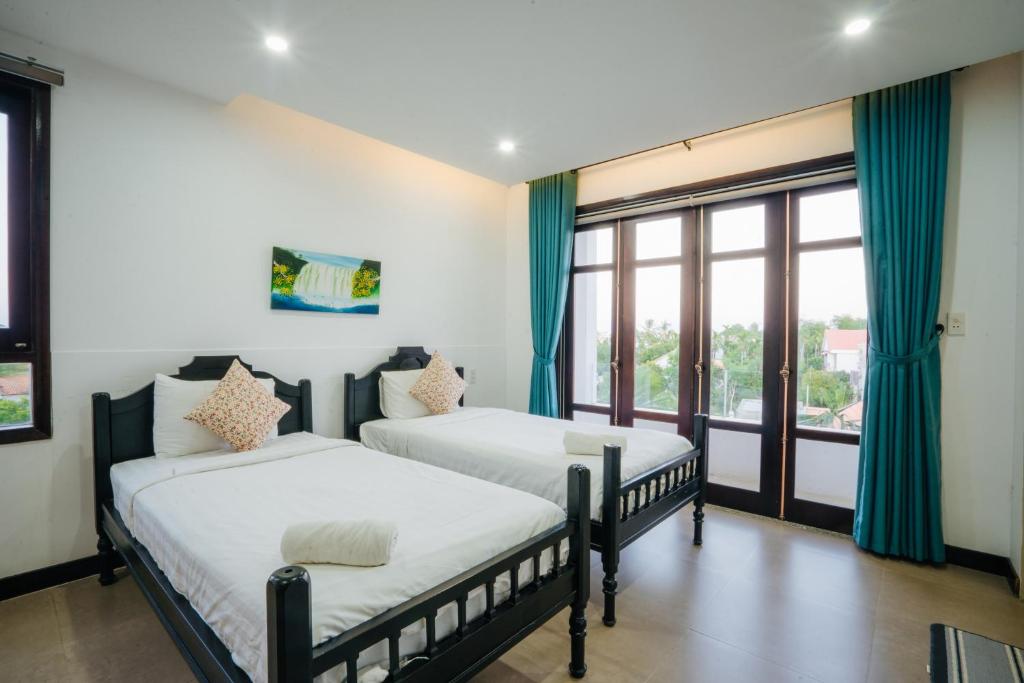 Postel nebo postele na pokoji v ubytování Hoi An Lotus Aroma Villa