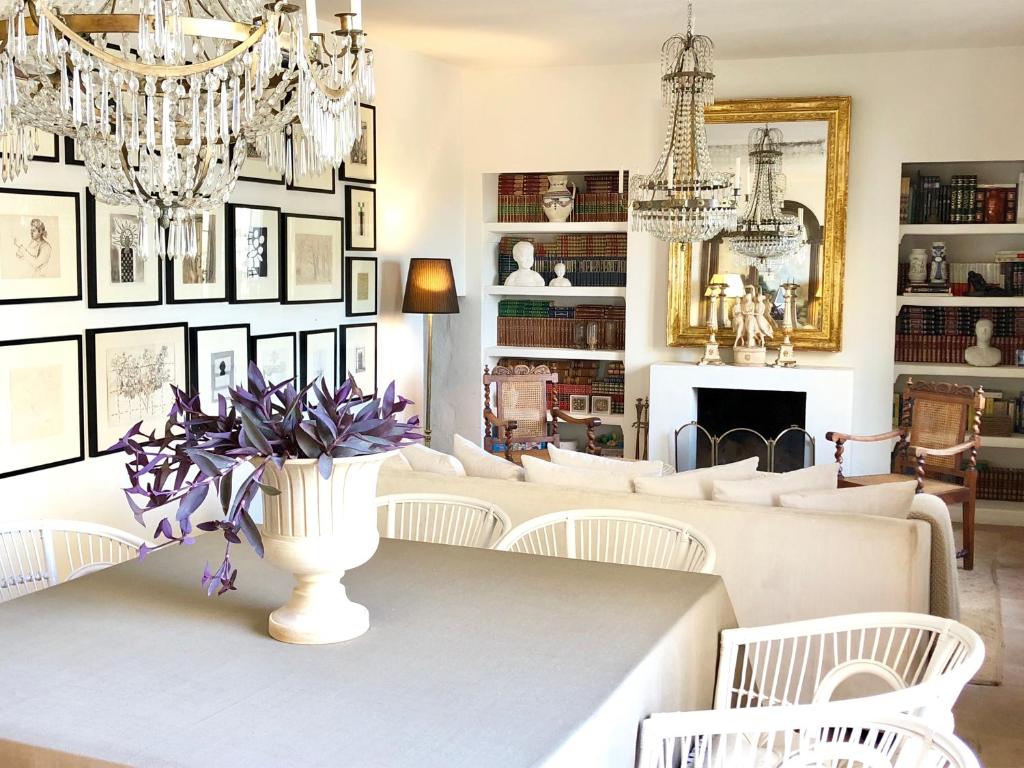 un comedor con una mesa con un jarrón de flores en La Casa del Jabonero, en Cuevas Bajas