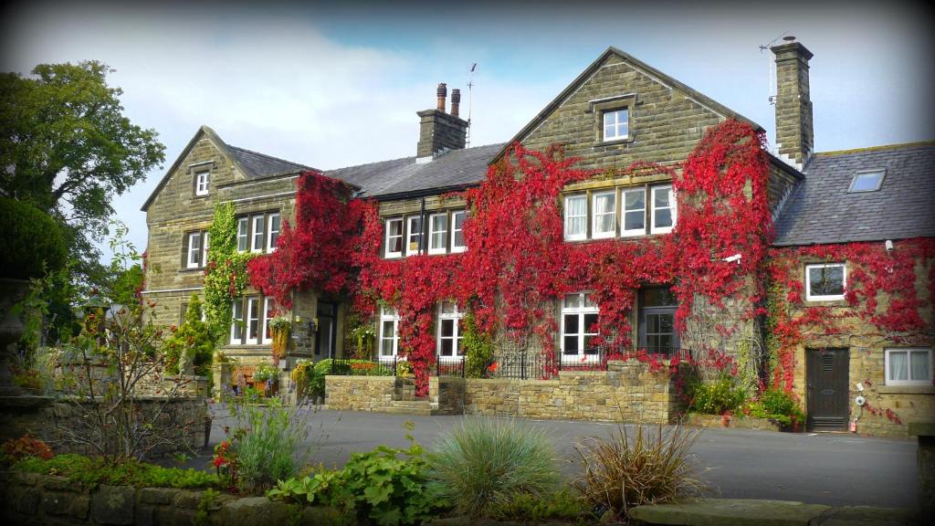 a house with red leaves on the side of it at Ferraris Country House Hotel in Longridge